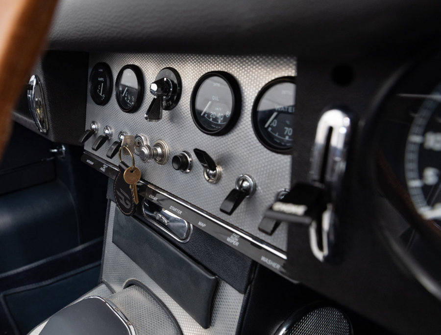 Closeup of an electric e-type Jaguar dashboard and keys converted by Electrogenic 
